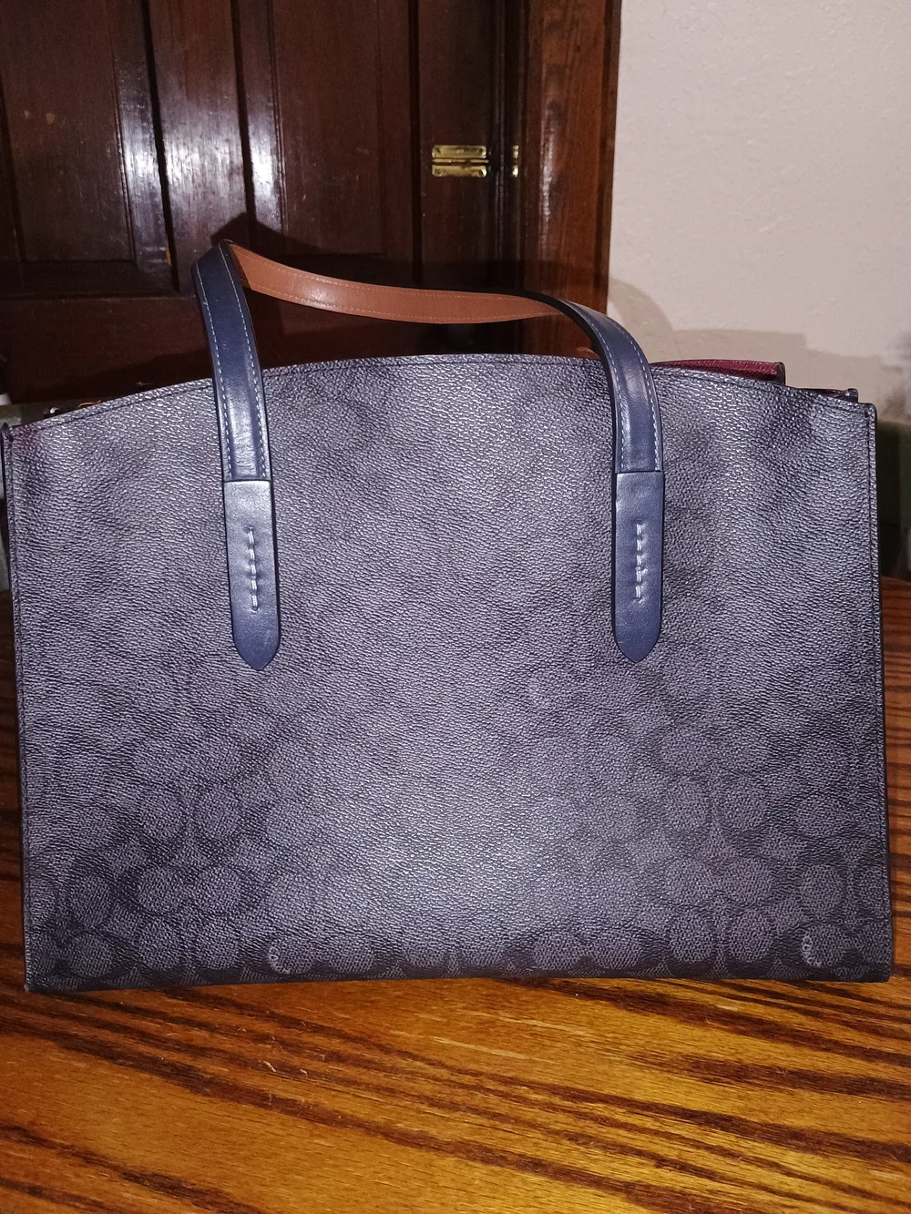 Coach Navy Signature Tote with A Wine Color Interior .